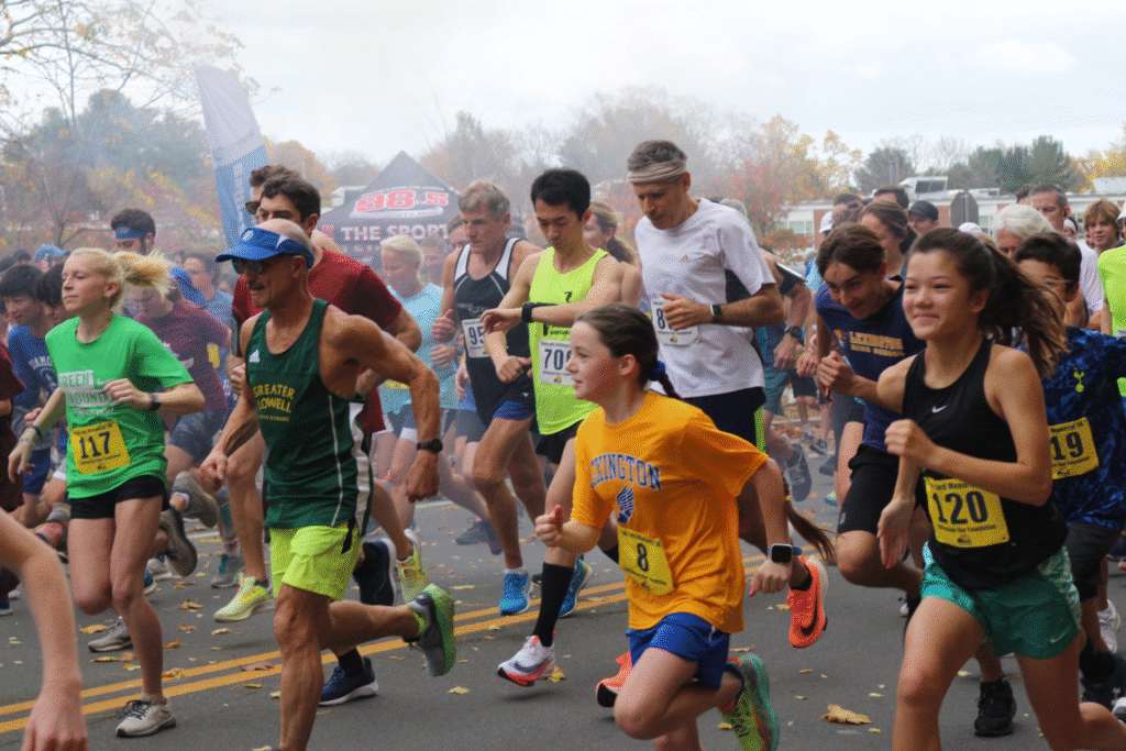 Community members running in a road race.